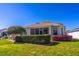 Exterior view of the home showcasing the screened lanai, landscaping, and well-kept lawn at 9458 Sw 93Rd Loop, Ocala, FL 34481