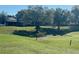 The backyard is very large with mature trees and lush green grass at 9458 Sw 93Rd Loop, Ocala, FL 34481