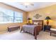 Comfortable bedroom with a large window, ceiling fan and carpet flooring at 9458 Sw 93Rd Loop, Ocala, FL 34481
