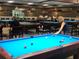Active billiards room featuring several tables, overhead lighting and large windows at 9458 Sw 93Rd Loop, Ocala, FL 34481