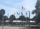 A community park featuring the American flag and several other flags in a landscaped outdoor gathering space at 9458 Sw 93Rd Loop, Ocala, FL 34481