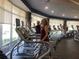 Well-equipped gym featuring treadmills, modern equipment, and large windows at 9458 Sw 93Rd Loop, Ocala, FL 34481