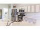 Charming kitchen features stainless steel appliances, granite countertops and white cabinets at 9458 Sw 93Rd Loop, Ocala, FL 34481