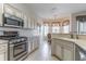 Well-equipped kitchen featuring stainless steel appliances and breakfast bar with sink at 9458 Sw 93Rd Loop, Ocala, FL 34481