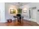 Relax in this piano room with an inviting piano, wood floors, and natural light at 9458 Sw 93Rd Loop, Ocala, FL 34481