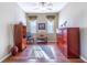 Cozy Sitting room with hardwood flooring, ceiling fan, and large windows at 9458 Sw 93Rd Loop, Ocala, FL 34481