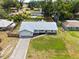 Aerial view of home with metal roof, large lot, landscaping and spacious driveway at 12453 Se 61St Ct, Belleview, FL 34420