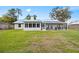 Enjoy a large backyard with a screened patio and well-maintained lawn, perfect for outdoor activities at 12453 Se 61St Ct, Belleview, FL 34420