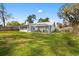 Expansive backyard with well-kept lawn, providing ample space for recreation and relaxation at 12453 Se 61St Ct, Belleview, FL 34420