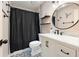 Modern bathroom featuring a vanity with a marble countertop, a black shower curtain, and sleek fixtures at 12453 Se 61St Ct, Belleview, FL 34420