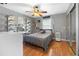Cozy bedroom with a ceiling fan, comfortable bed, and plenty of natural light from the window at 12453 Se 61St Ct, Belleview, FL 34420