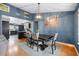 Elegant dining room showcasing contemporary lighting, a dark wood table, and views into the kitchen at 12453 Se 61St Ct, Belleview, FL 34420