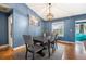 Dining area with a modern chandelier, dining table set, and a large window at 12453 Se 61St Ct, Belleview, FL 34420