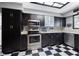 Well-equipped kitchen boasts stainless steel appliances, dark cabinetry, and ample counter space at 12453 Se 61St Ct, Belleview, FL 34420