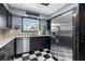 Stylish kitchen with stainless steel appliances, sleek dark cabinetry, and granite countertops at 12453 Se 61St Ct, Belleview, FL 34420