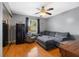 Cozy living room with comfortable seating, a ceiling fan, and a mini refrigerator at 12453 Se 61St Ct, Belleview, FL 34420