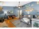Stylish living room with modern decor, a comfortable sectional sofa, and a unique lighting fixture at 12453 Se 61St Ct, Belleview, FL 34420