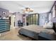 This is a main bedroom with a walk-in closet, an ensuite bath, and a ceiling fan at 12453 Se 61St Ct, Belleview, FL 34420