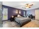 This is a spacious main bedroom with a work space, a ceiling fan, and natural light at 12453 Se 61St Ct, Belleview, FL 34420