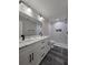 Bathroom featuring double sinks, marble countertops, and a tiled walk-in shower at 13 Locust Trak, Ocala, FL 34472