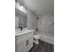 Modern bathroom with white vanity, toilet, shower, and tiled tub at 13 Locust Trak, Ocala, FL 34472