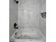 Bathroom tub with marble-patterned tiles and black fixtures at 13 Locust Trak, Ocala, FL 34472