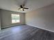 Spacious bedroom features hardwood floors, ceiling fan, and bright window at 13 Locust Trak, Ocala, FL 34472