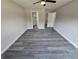 The spacious bedroom features hardwood floors, ceiling fan, bathroom, and walk-in closet at 13 Locust Trak, Ocala, FL 34472