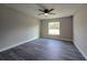 Bedroom features hardwood floors, ceiling fan, and bright window at 13 Locust Trak, Ocala, FL 34472