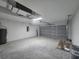 Spacious two car garage with a water heater, electrical panel, and overhead lighting at 13 Locust Trak, Ocala, FL 34472