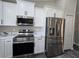 Modern kitchen with stainless steel appliances and white cabinetry at 13 Locust Trak, Ocala, FL 34472