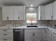 Updated kitchen showcasing white cabinets, stainless steel appliances and countertops at 13 Locust Trak, Ocala, FL 34472