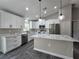 Modern kitchen with white cabinets, marbled countertops, and stainless steel appliances at 13 Locust Trak, Ocala, FL 34472