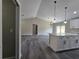 Open-concept living room with modern floors and an island kitchen at 13 Locust Trak, Ocala, FL 34472