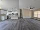 Spacious living room featuring modern gray flooring and an open floor plan connecting to the kitchen at 13 Locust Trak, Ocala, FL 34472