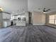 Open-concept living space showcasing the kitchen with white cabinets and stainless appliances at 13 Locust Trak, Ocala, FL 34472