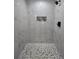 Walk-in shower featuring white tile and a decorative shower floor at 13 Locust Trak, Ocala, FL 34472