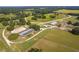 Expansive horse farm with a racetrack, barns, stables, and lush green pastures, providing ample space for equestrian activities at 13800 Ne Jacksonville Road, Citra, FL 32113