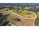 An aerial view showcasing the horse racetrack, surrounded by trees and fields at 13800 Ne Jacksonville Road, Citra, FL 32113