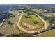 Aerial shot of the horse racetrack and surrounding fields, offering a view of the farm's expansive layout at 13800 Ne Jacksonville Road, Citra, FL 32113