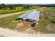 Modern barn with ample covered space for horses, surrounded by lush pastures, perfect for an equestrian lifestyle at 13800 Ne Jacksonville Road, Citra, FL 32113