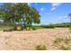 A tractor preps the grounds of the property; beautiful mature trees in the background at 13800 Ne Jacksonville Road, Citra, FL 32113