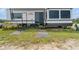 Exterior view of a modern RV, featuring an entry door, windows, and leveling system at 13800 Ne Jacksonville Road, Citra, FL 32113