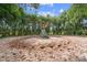 An older horse exerciser sits in a fenced, sandy lot with mature trees in the background at 13800 Ne Jacksonville Road, Citra, FL 32113