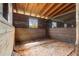 Rustic, wooden horse stall with window and blue metal bars at 13800 Ne Jacksonville Road, Citra, FL 32113