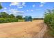 View of the training track starting gate, surrounded by sand, grass, and mature trees at 13800 Ne Jacksonville Road, Citra, FL 32113