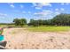 View of a horse paddock with horses, green grass, and wooden fencing at 13800 Ne Jacksonville Road, Citra, FL 32113