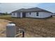 A cozy, single-story home with lots of green space around it and a covered patio in the back at 17 Laurel Pass Ln, Ocala, FL 34480