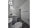 Bathroom features double vanity, modern fixtures, and sleek gray flooring at 17 Laurel Pass Ln, Ocala, FL 34480