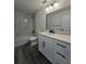 A modern bathroom features a shower-tub combo, white marble backsplash, and sleek black accents at 17 Laurel Pass Ln, Ocala, FL 34480